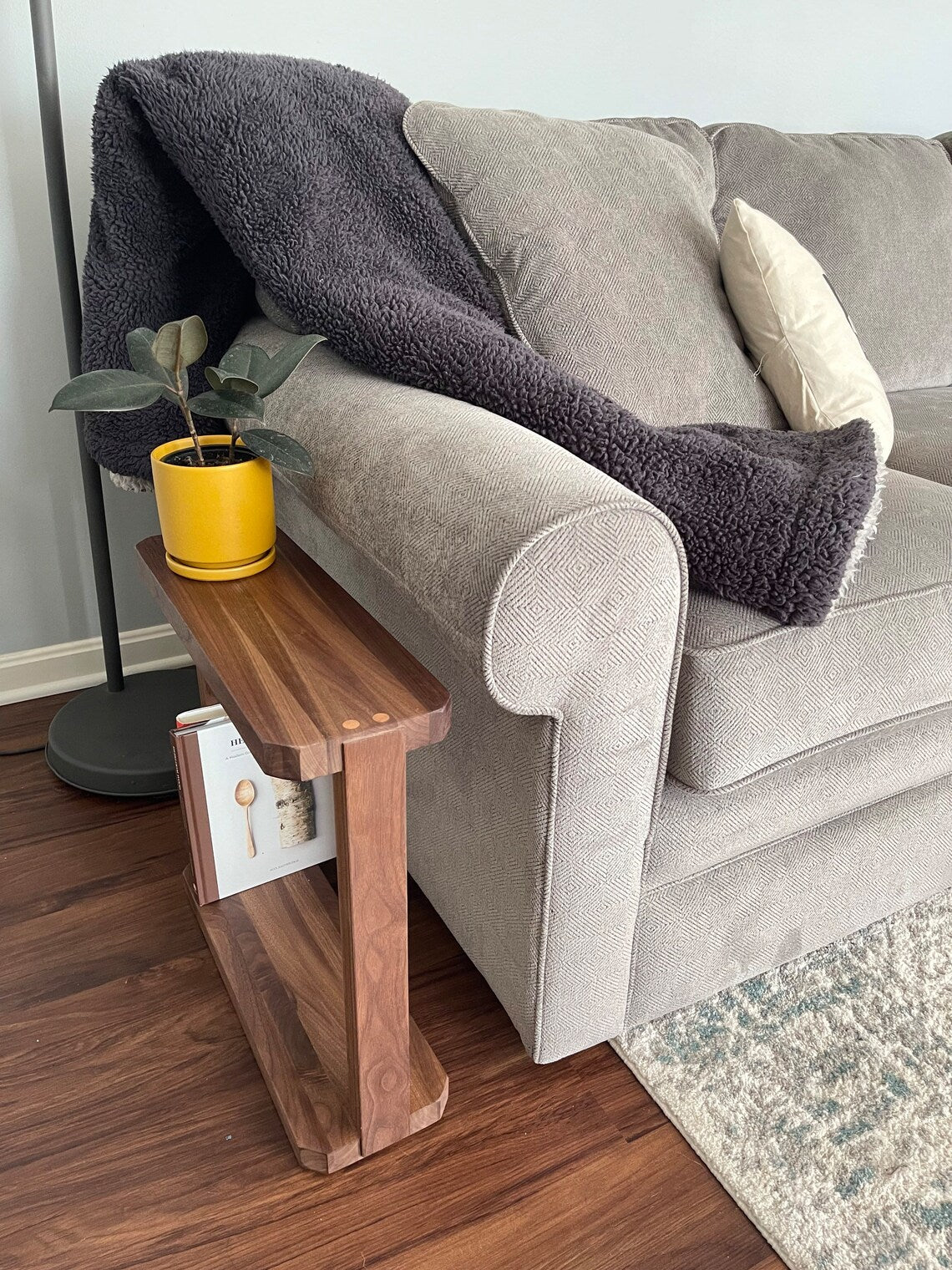 A brilliant piece for the home, this end table is the perfect size next to a couch. Featuring natural wood legs, it has a spacious top surface for books or for setting drinks.