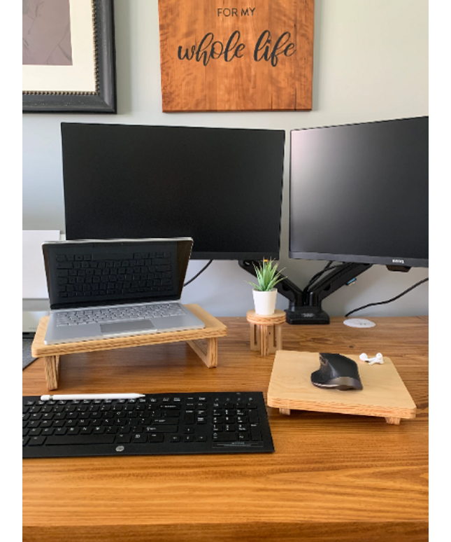 Laptop stand and matching wooden mouse pad set up on a desk, displaying a cohesive and functional workspace
