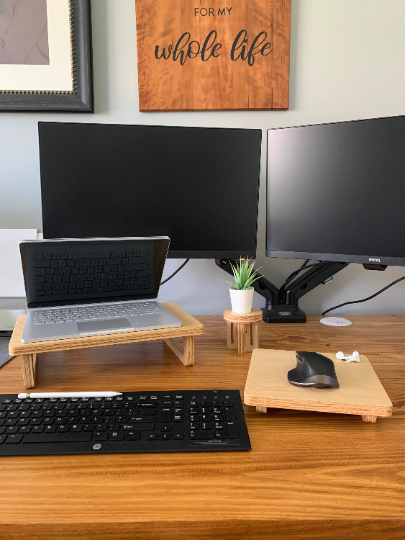 Laptop stand and matching wooden mouse pad set up on a desk, displaying a cohesive and functional workspace