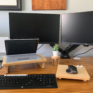 Laptop stand and matching wooden mouse pad set up on a desk, displaying a cohesive and functional workspace