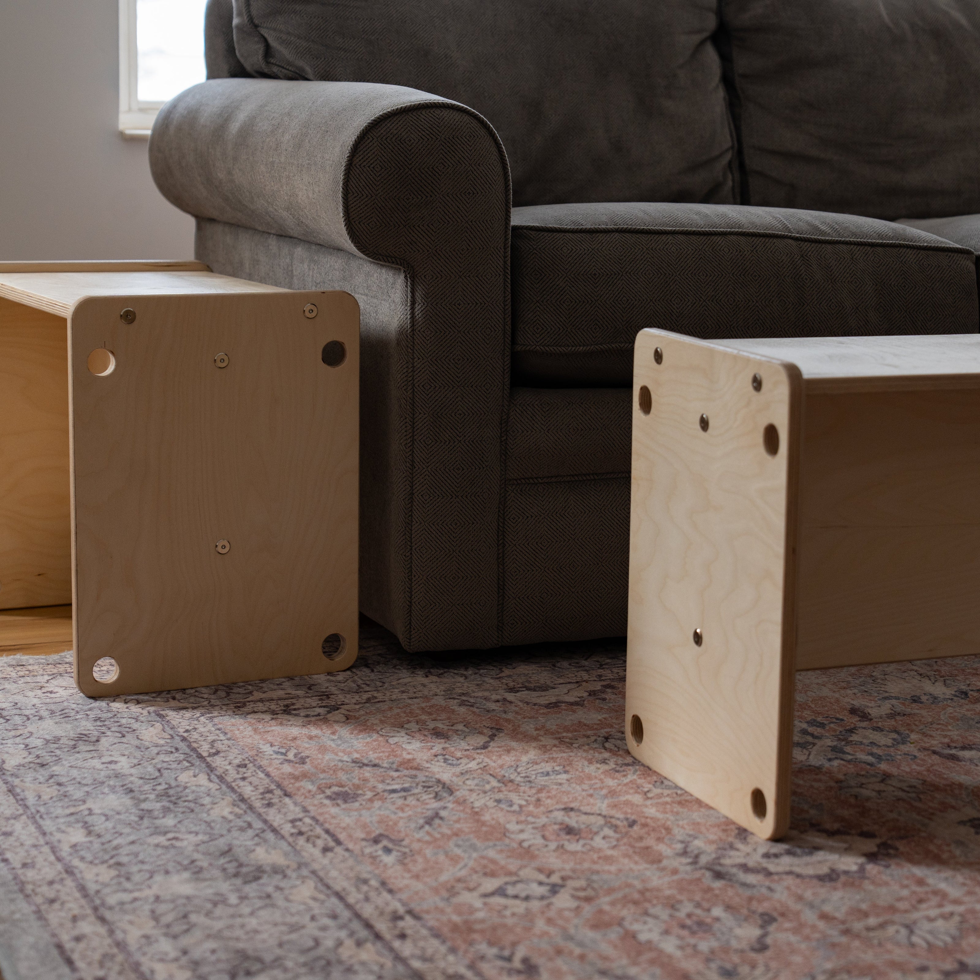 Wooden kids chair flipped into adult side table next to couch
